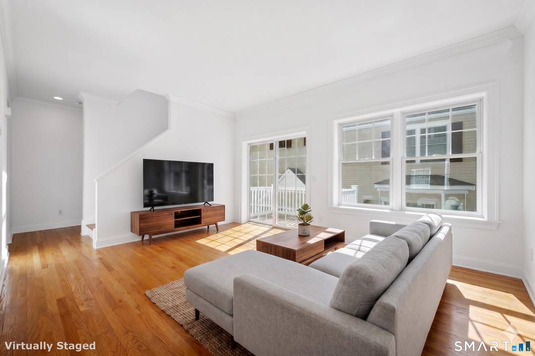 Experience luxurious, carefree living in this immaculate tri level townhouse, located less than a mile from the heart of town.