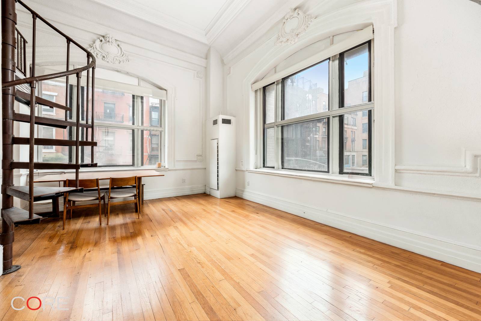 Located in the heart of Greenwich Village, this unique corner duplex features soaring 15 foot ceilings, intricate moldings, hardwood floors, and a sleep loft that can accommodate queen sized furniture.