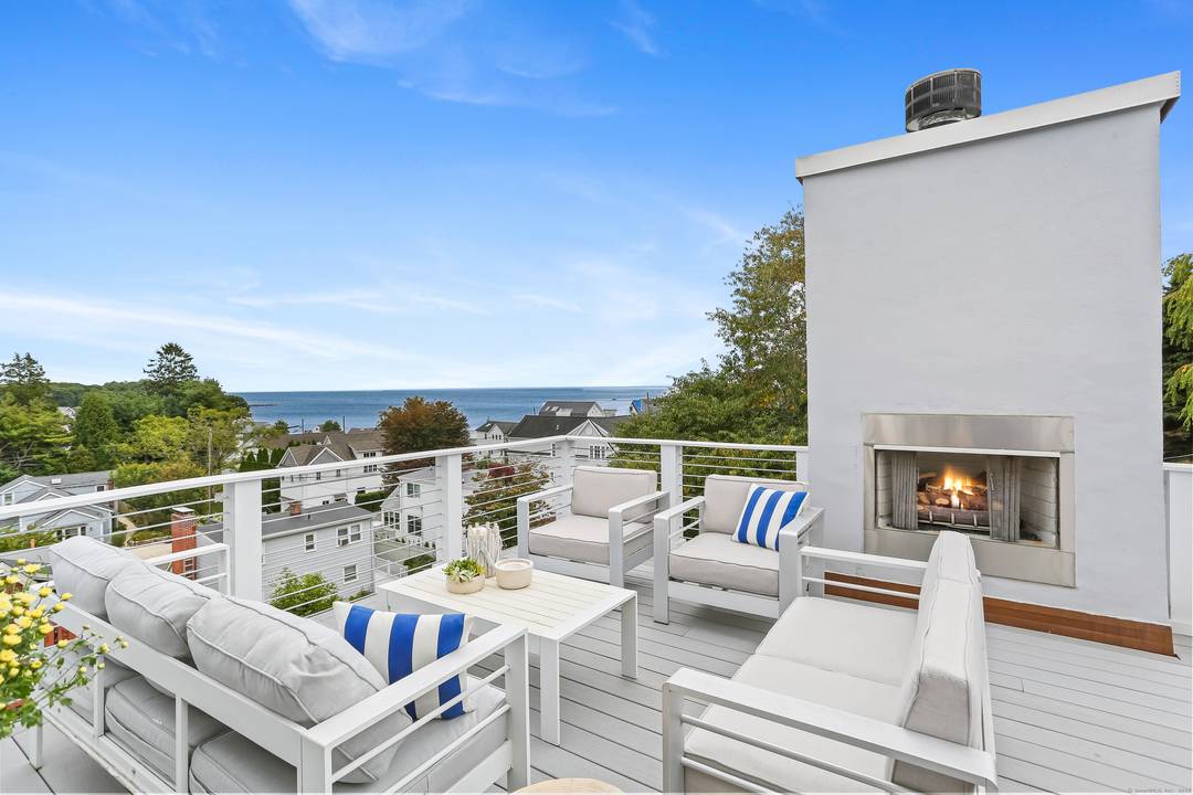 Nestled in privacy by nearly 100 arborvitaes, this ultimate retreat on a rare double lot is just steps from Old Mill Beach Compo Beach.