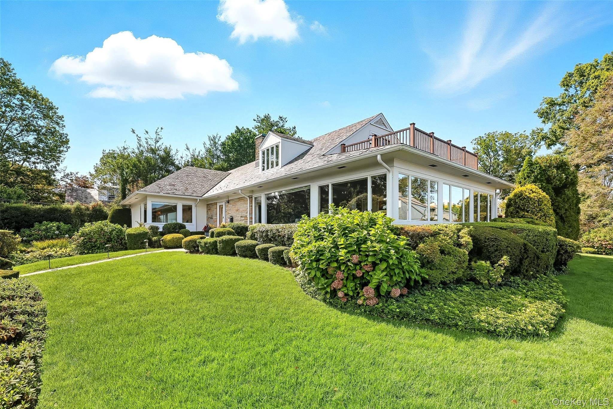 Nestled in the heart of The Manor, this easy living home offers water views of Larchmont Harbor and a rare.