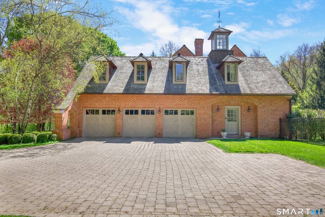 Nestled at the end of an exceptionally wide, tree lined cul de sac on one of Westport's most picturesque streets, this timeless brick estate offers both elegance and privacy while ...