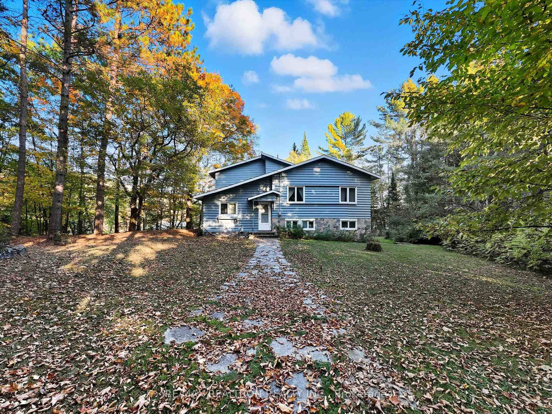 Nestled on scenic Mary Lake in Huntsville's coveted Chain of Four Lakes, this fully winterized waterfront retreat offers 330 ft of shoreline and 1.