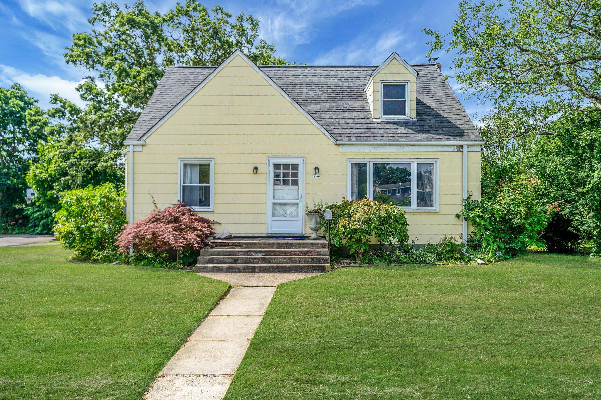 Welcome to 4 Jones St N, Patchogue, NY a charming 3 bedroom, 2 bath cape situated on a desirable corner lot in a prime Patchogue location.