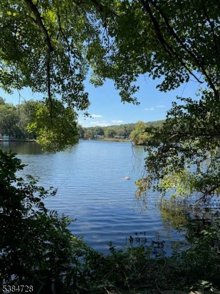 Experience the best of lakefront living in this spacious, custom home set directly on the shores of Cedar Lake.