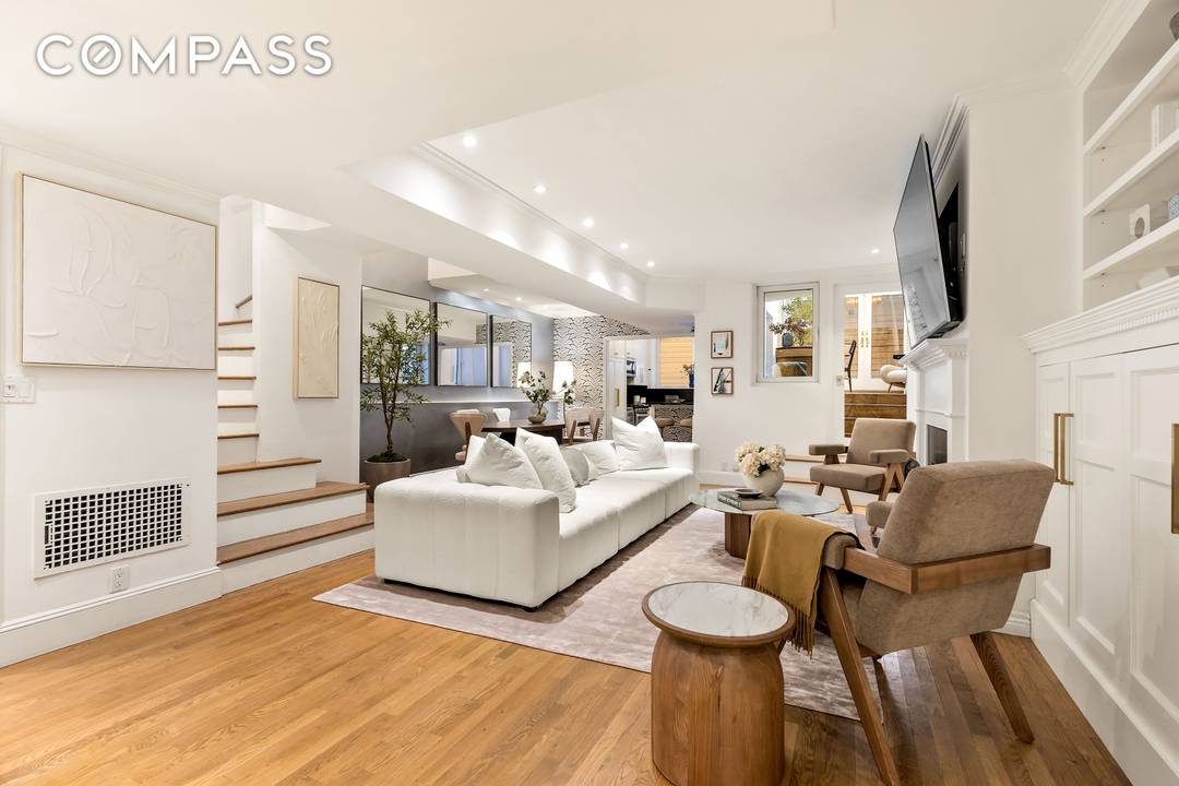 A rare and sophisticated south facing garden duplex nestled within a historic landmarked mansion on one of Manhattan s most coveted blocks just moments from Central Park.