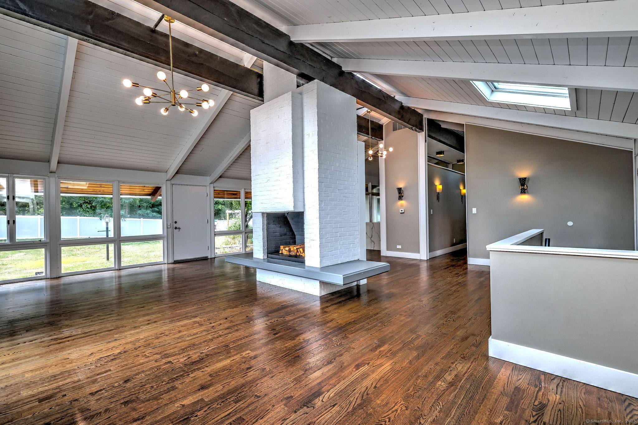 Welcome to 65 High Meadow, a beautifully updated Mid Century Modern home originally designed by Earl Carlin of Pozzi Carlin located in the heart of Spring Glen.