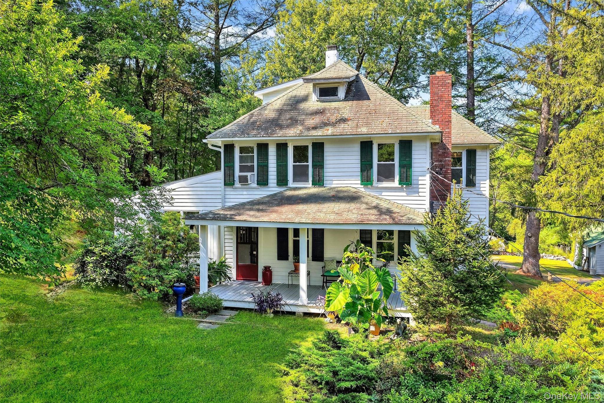 In the Hamlet of Huntersville, this picturesque circa 1920 farmhouse sits privately on almost 1.