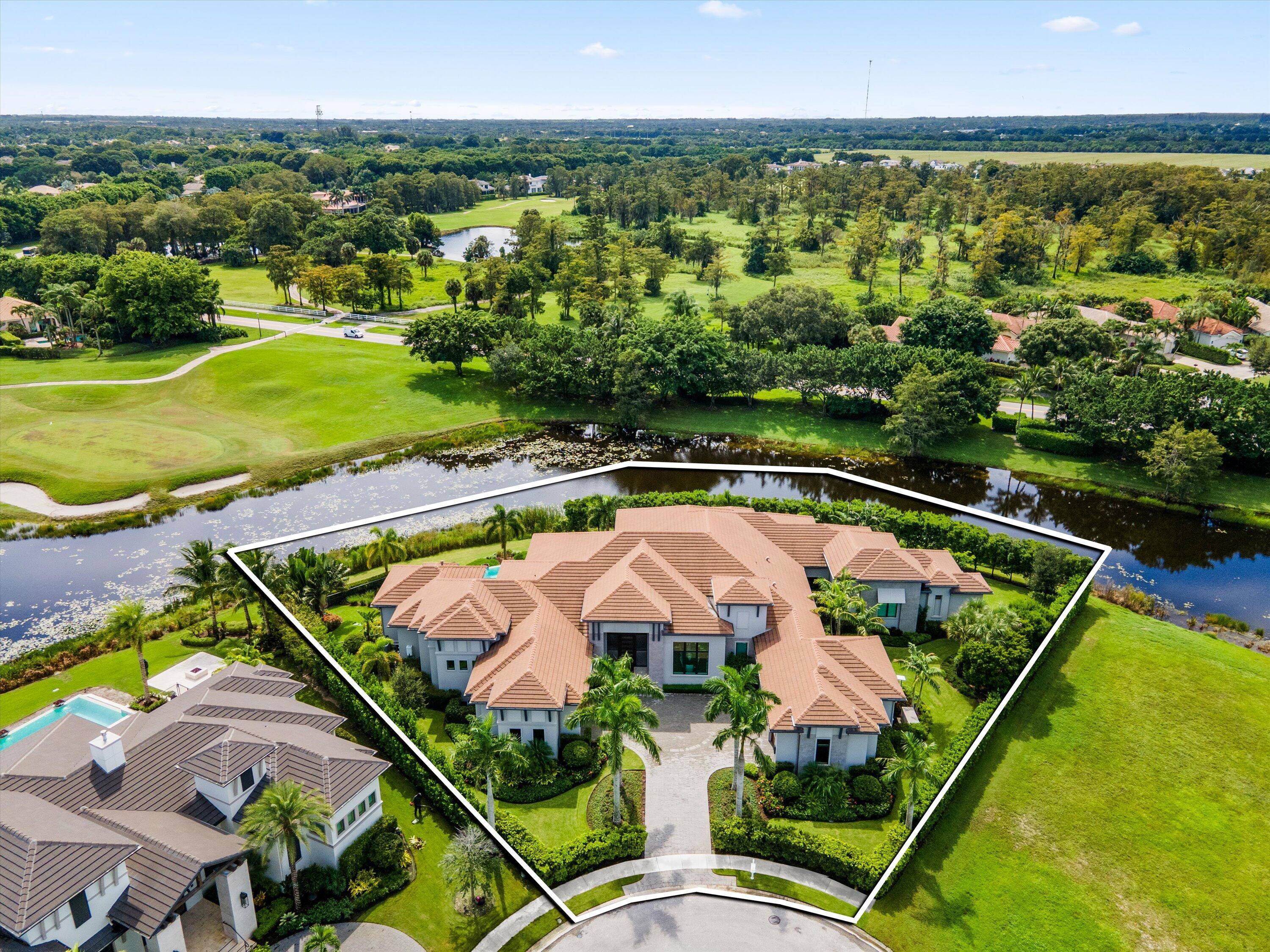 Nestled within the exclusive, gated golf community of Palm Beach Polo, this newly built estate by Stock Custom Homes is set on a waterfront 0.