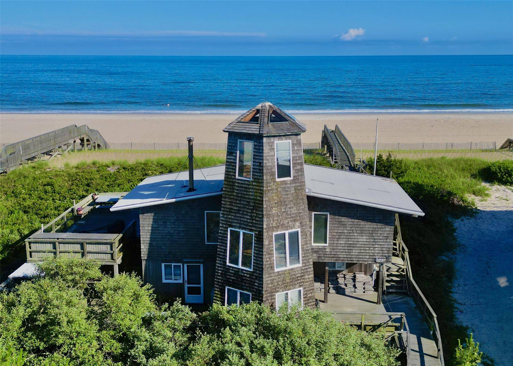 Welcome to The Tower House, a renowned architectural gem perched directly on the oceanfront in the heart of Davis Park, Fire Island.