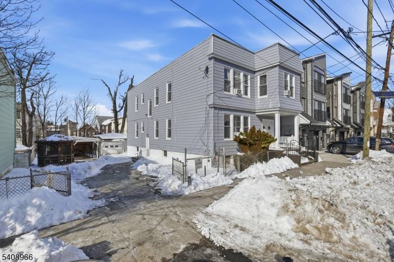 Unique package deal offering Buildable lot Two family home features a total of 5 bedrooms, 3 full bathrooms, and a finished basement.