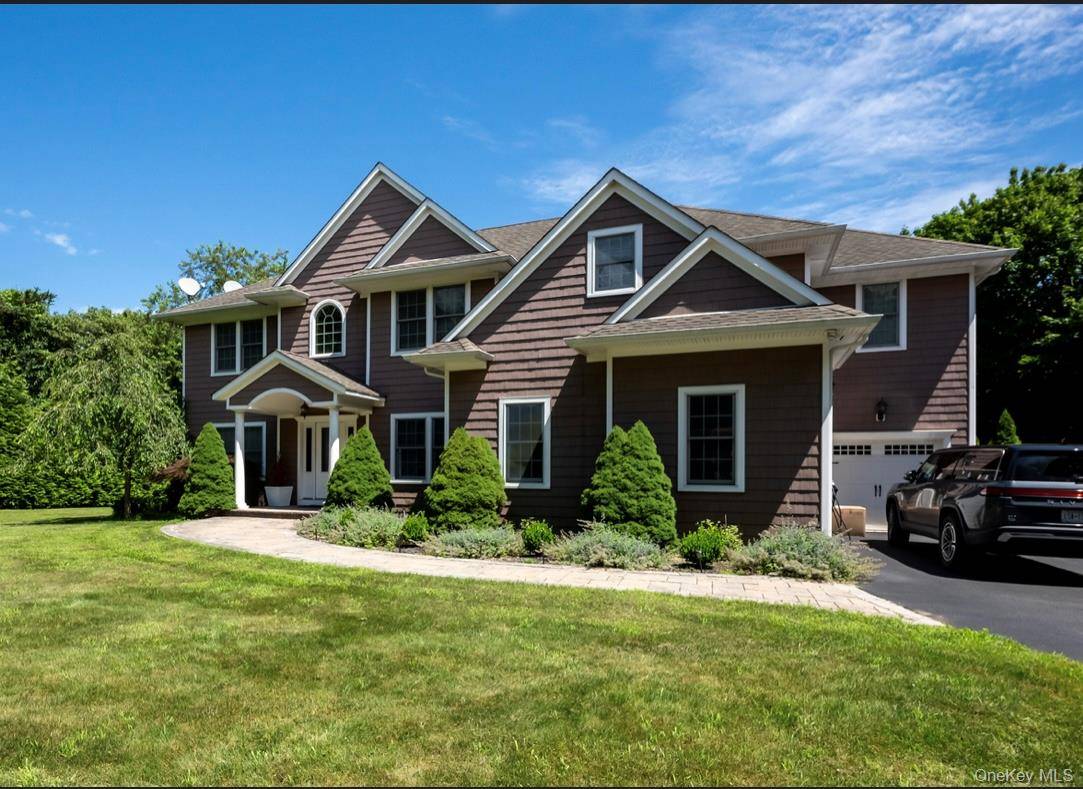 Drive down a picturesque, tree lined driveway and arrive at this stunning post modern home nestled on a spacious, 1.