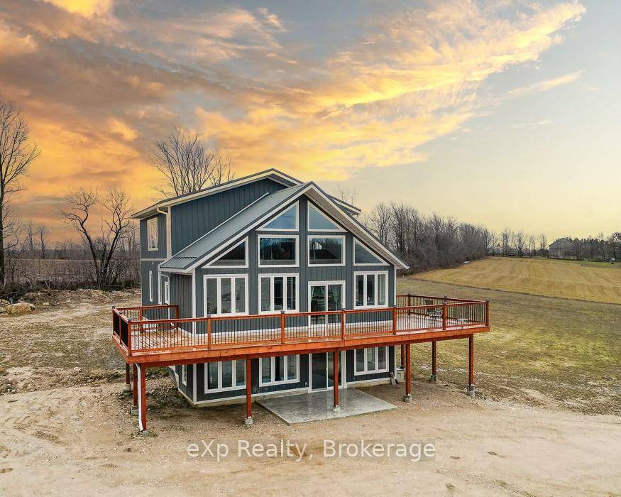 Nestled atop a hill, this elegant new home is set on just under 5 acres.