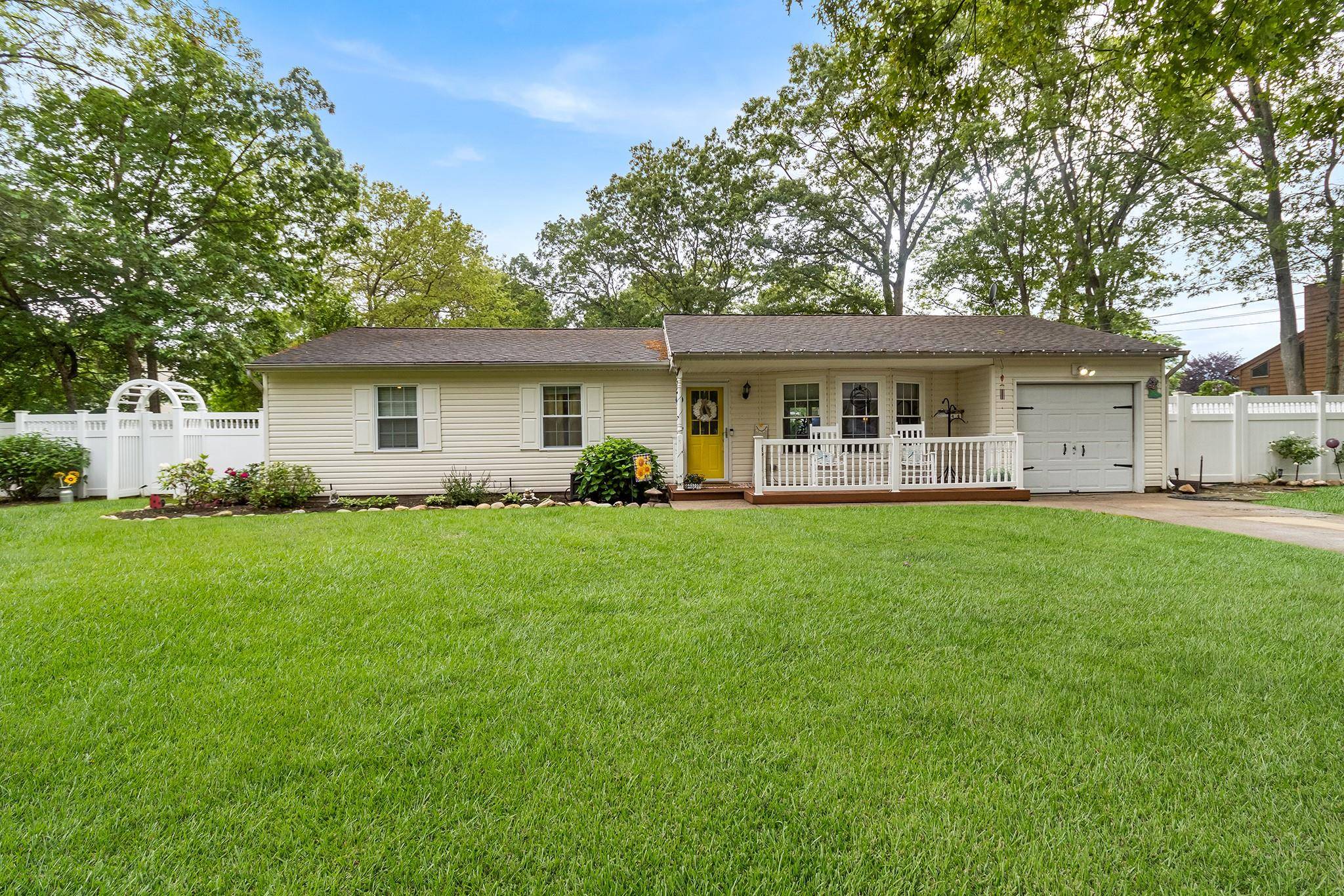 Welcome to 44 Lowell Ave in Holtsville this charming ranch offers impressive curb appeal with vinyl siding, manicured landscaping, and a long driveway for multiple vehicles.