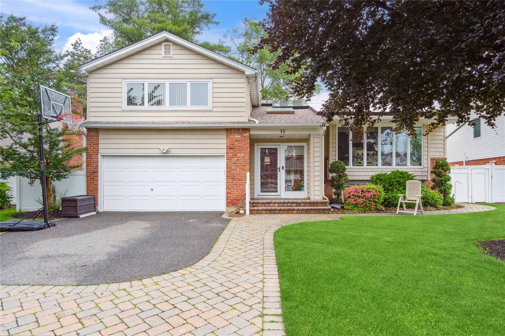 Bright and spacious expanded Suburban Greens Hi Ranch in the Manetto Hills Section of Plainview.