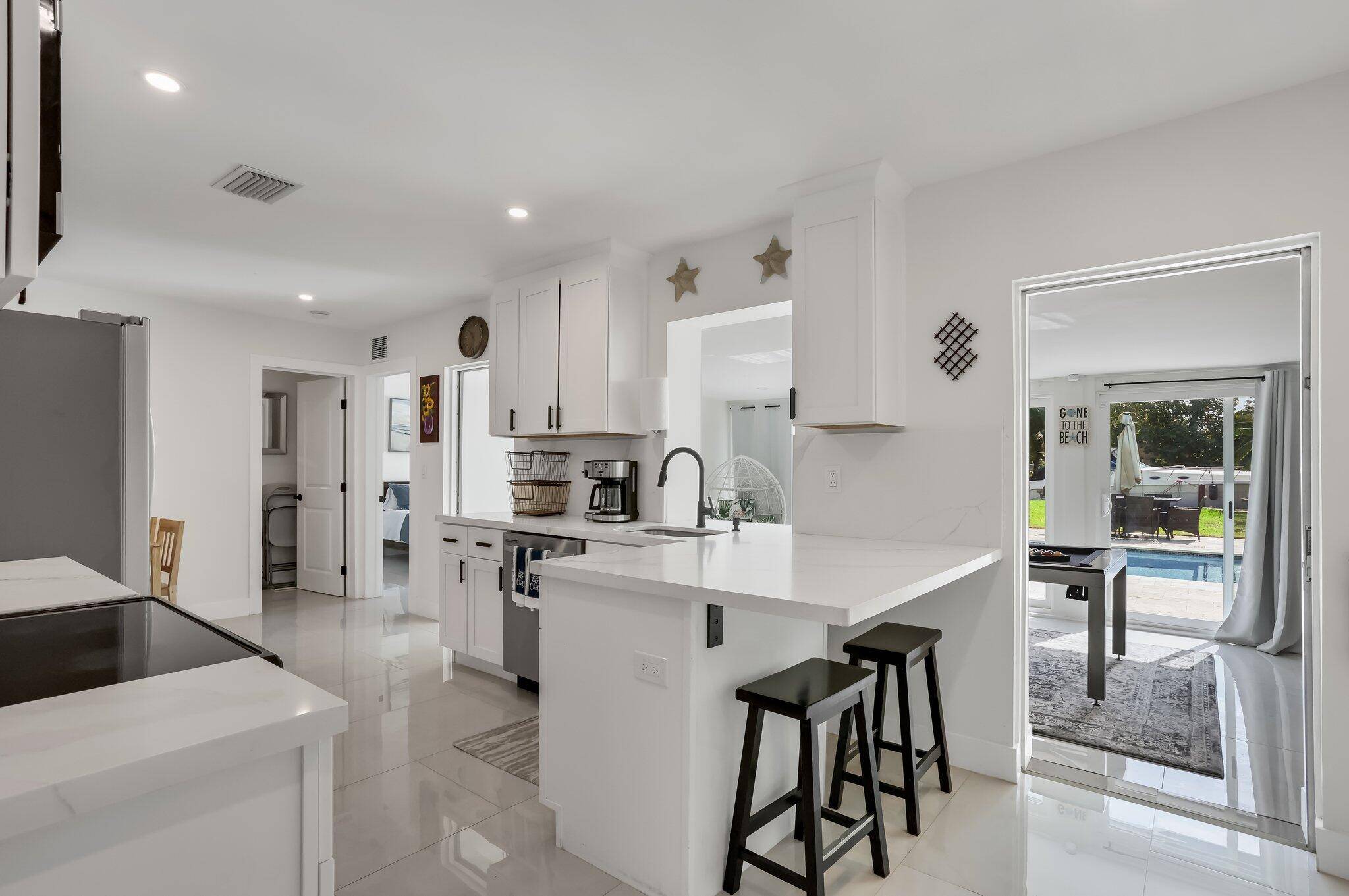 Welcome to your waterfront dream and income producing powerhouse all wrapped into one perfectly curated home in Fort Lauderdale Dania Beach.