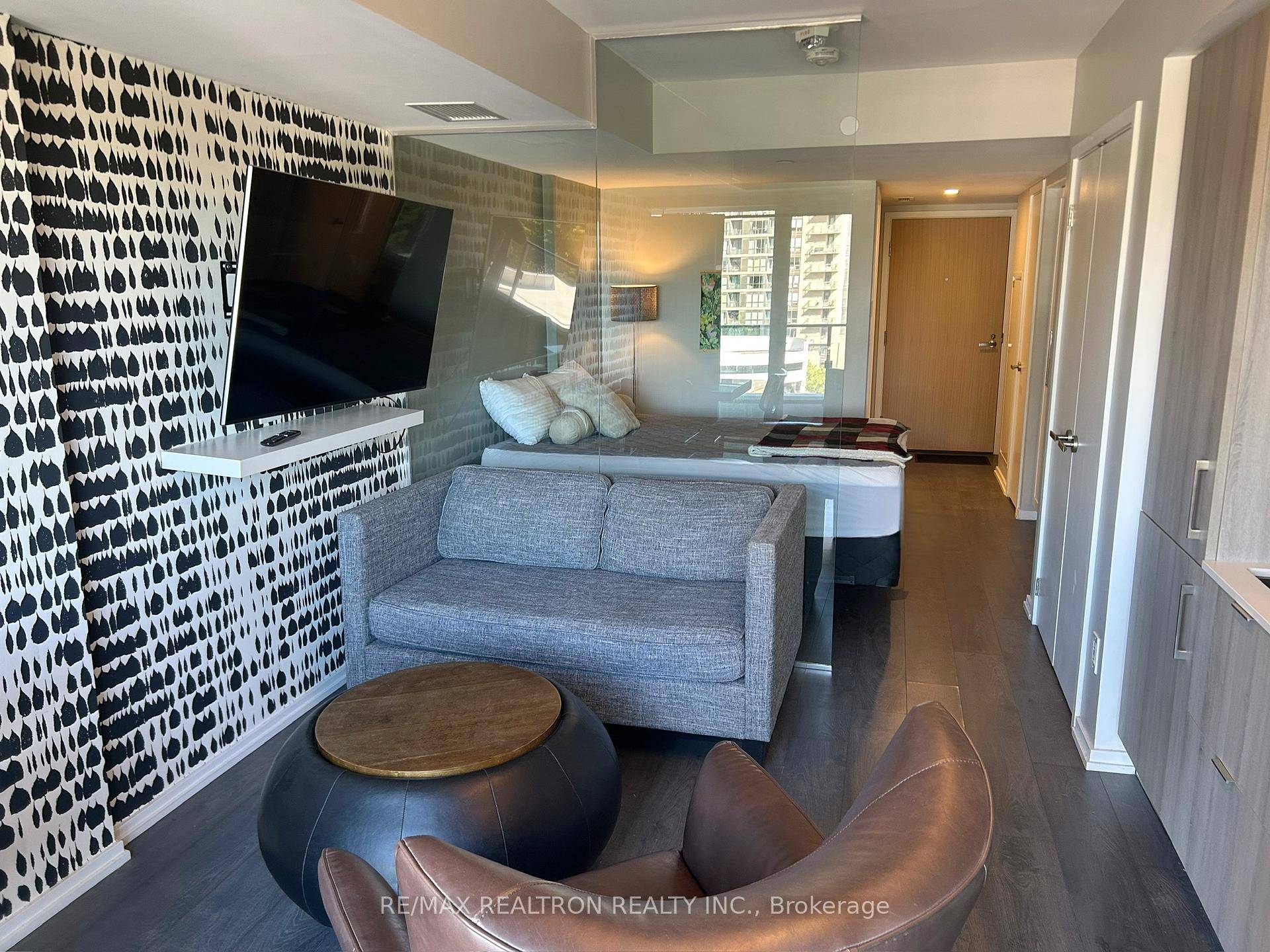 Beautifully upgraded suite at The Art Shoppe, defined by the builder as a Junior 1 Bedroom, with a sleek glass partition creating separation between living amp ; sleeping areas.