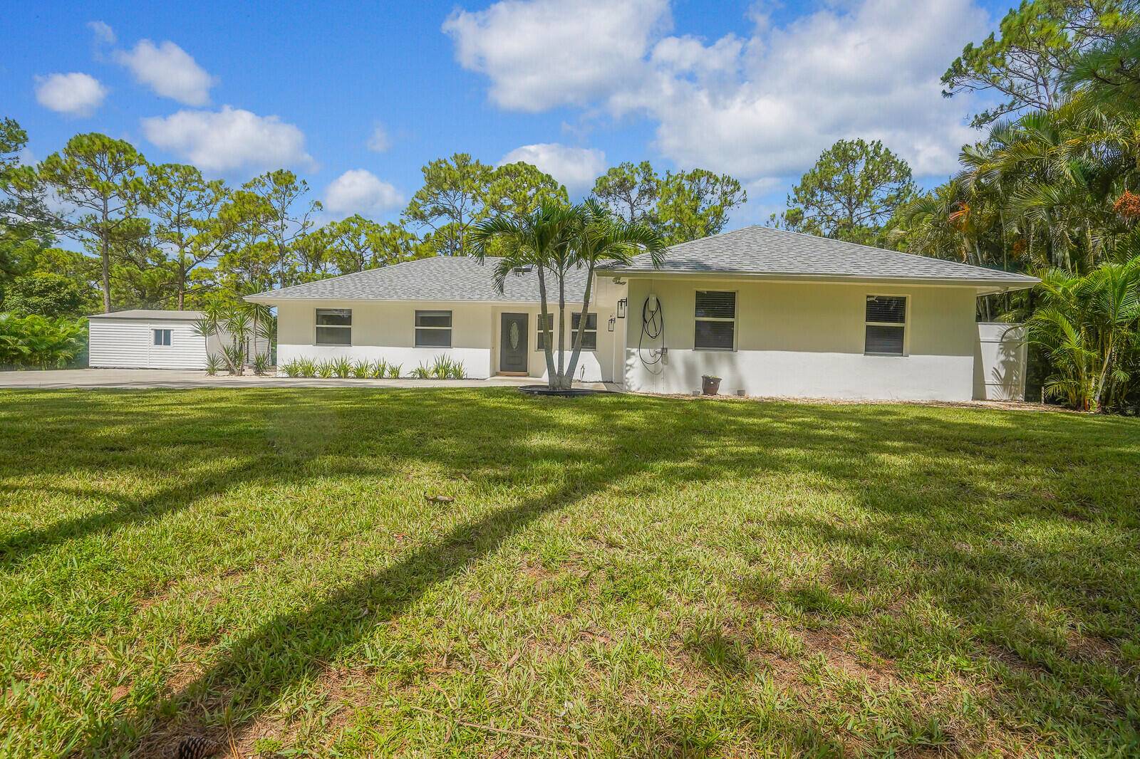 Beautifully newly remodeled home with 3 bedrooms, a den, 2 bathrooms with extra large air conditioned storage building.