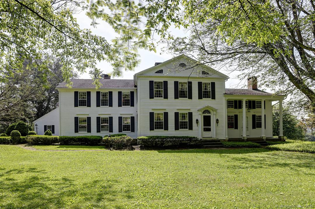 This grand 1805 Colonial has high ceilings and original details including many triple hung windows, fireplaces with carved stone surrounds and mantles, and wide board floors.