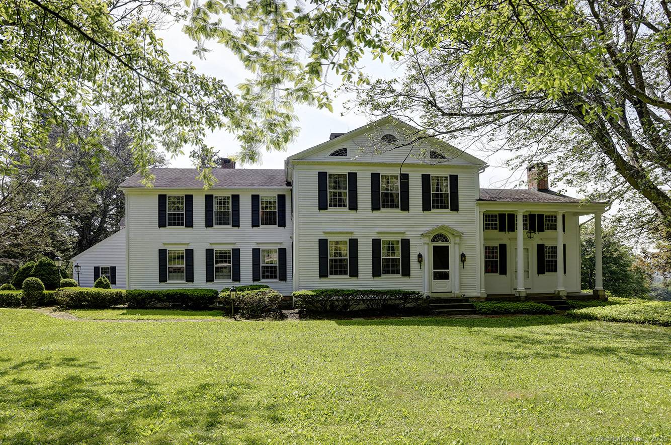 This grand 1805 Colonial has high ceilings and original details including many triple hung windows, fireplaces with carved stone surrounds and mantles, and wide board floors.