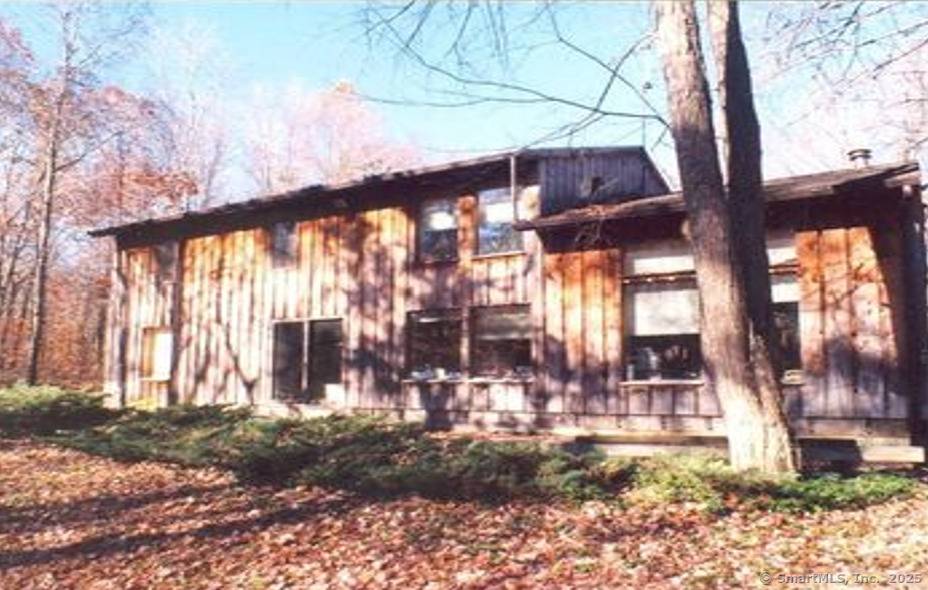 The charming 3 bedroom colonial with a large attached garage and 2 outbuildings overlooks a lovely 5 acre pond.