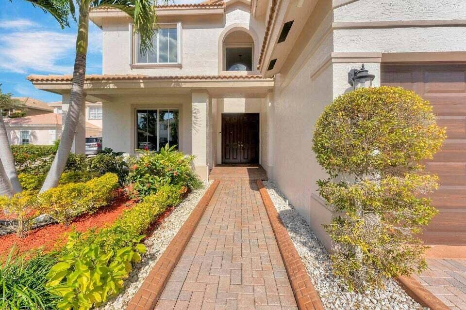 Step inside and be greeted by the grand double door entry, soaring ceilings, and expansive windows that frame the majestic lake views.