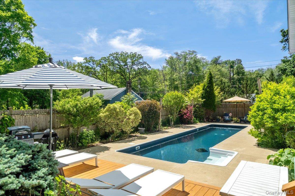 Beautifully updated turnkey mini estate on just under an acre offers all of the easy maintenance of a condo without the HOA.