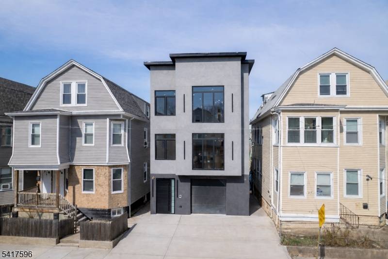 A statement of sophistication and craftsmanship, this custom new construction two family residence redefines modern living in Irvington, NJ.