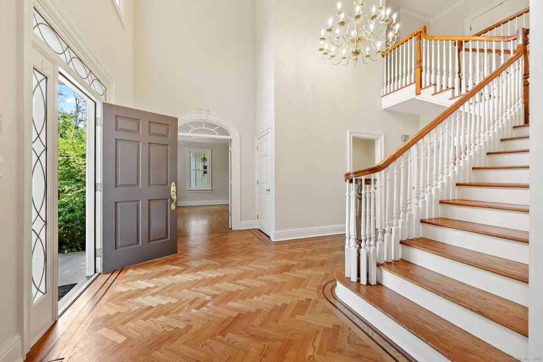 Gracious center hall colonial set back from road.