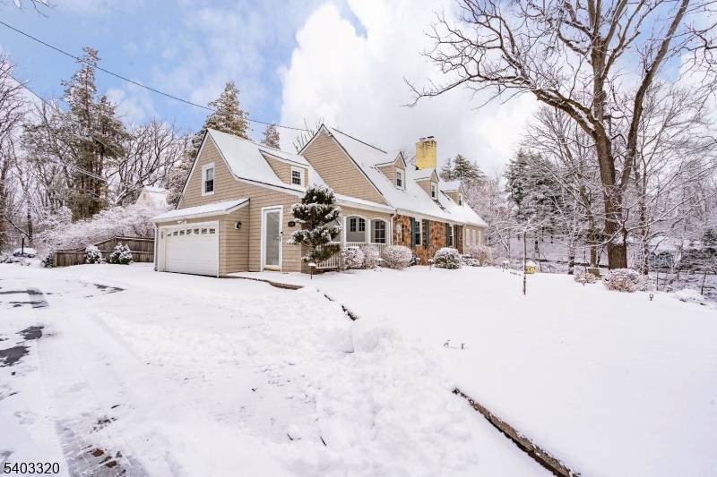 Perched on a hill along New Providence Road, this two story ranch offers strong curb appeal, visibility, and a spacious property in desirable Mountainside.