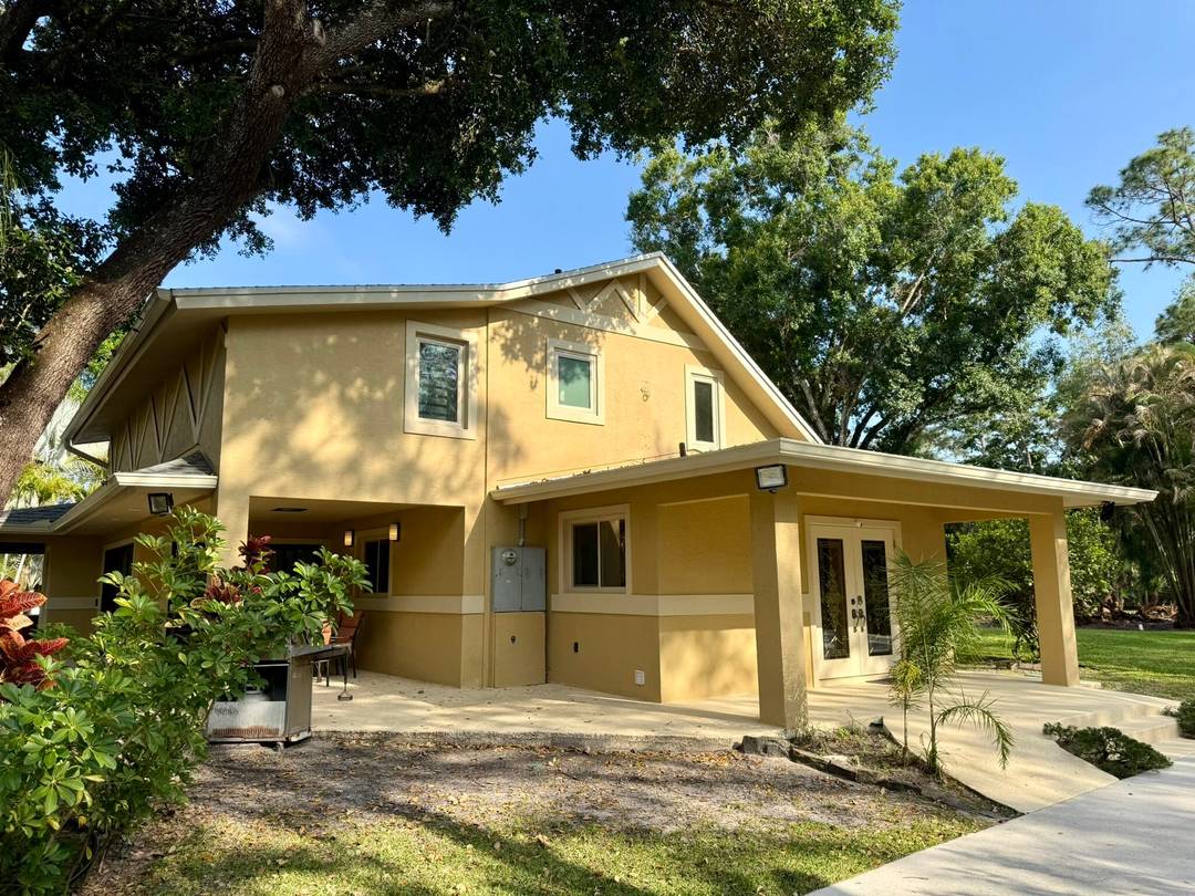 Rare, custom concrete, 2 building estate on paved roads in Jupiter Farms.