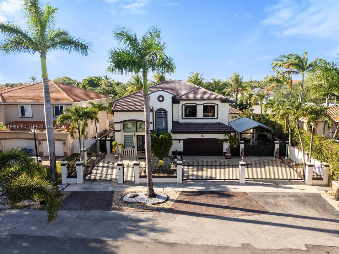 Welcome to 7777 NW 169th Terrace, a true gem located in the highly sought after gated community of Royal Oaks in Miami Lakes.