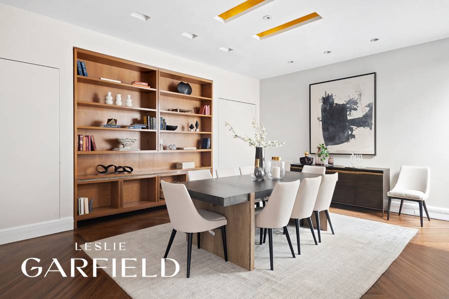 This duplex apartment, located within a historic Upper East Side carriage house, offers a private garage and outdoor space.