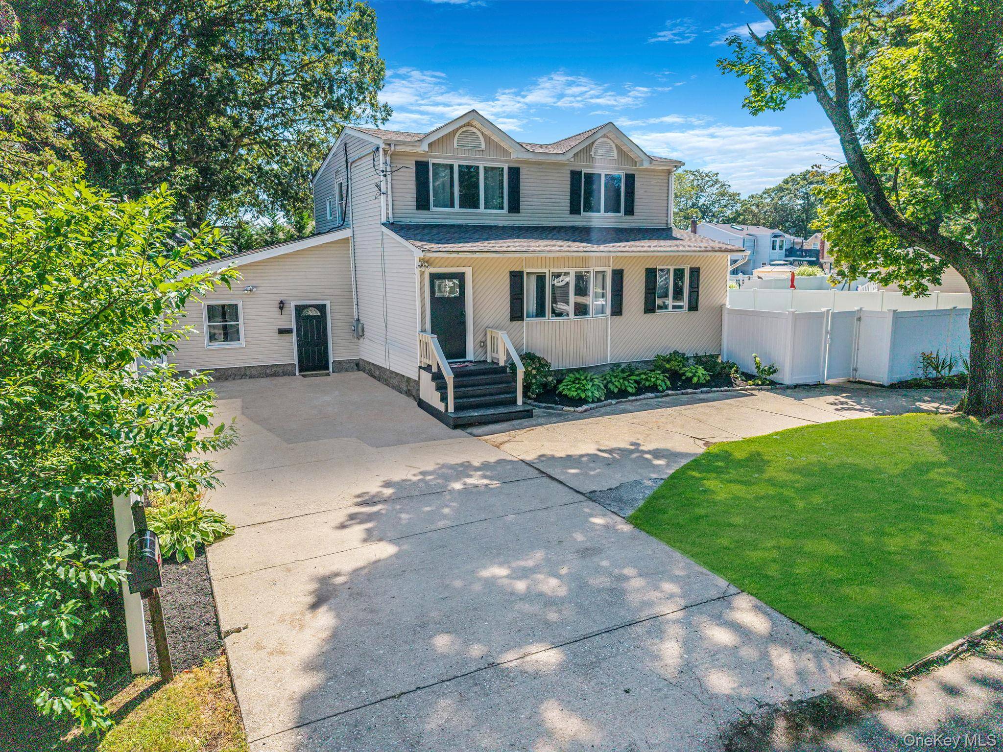 Beautiful West Islip Colonial on a huge double lot with park like grounds.