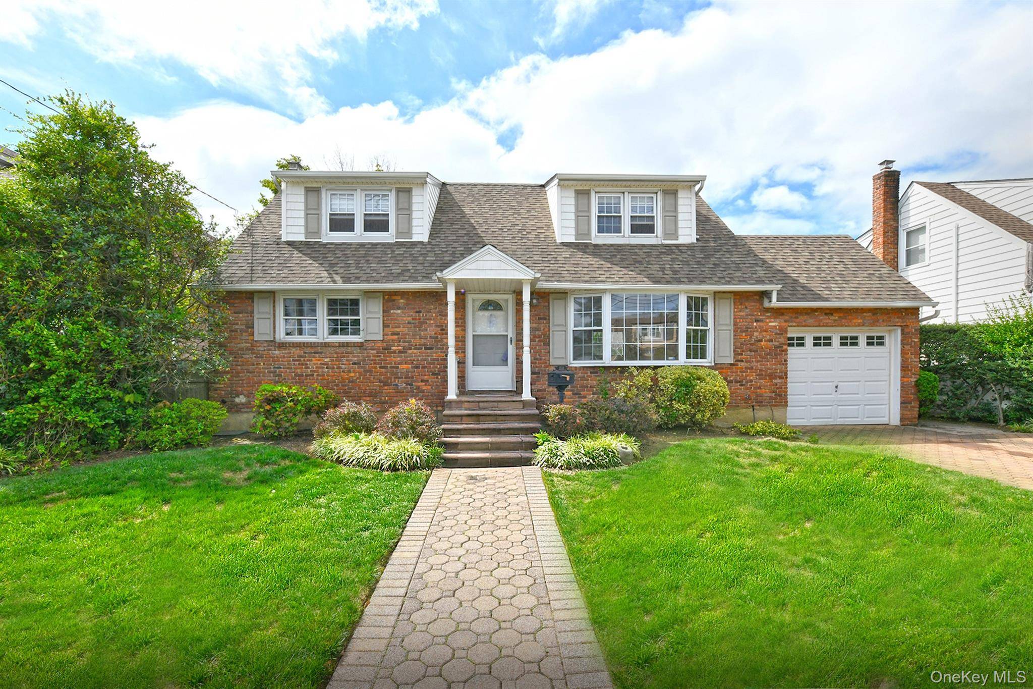 Welcome home to this beautiful brick cape in the heart of North Bellmore.