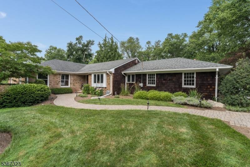 A blend of elegance and privacy in this vast picturesque custom ranch, nestled on over an acre of professionally landscaped grounds.