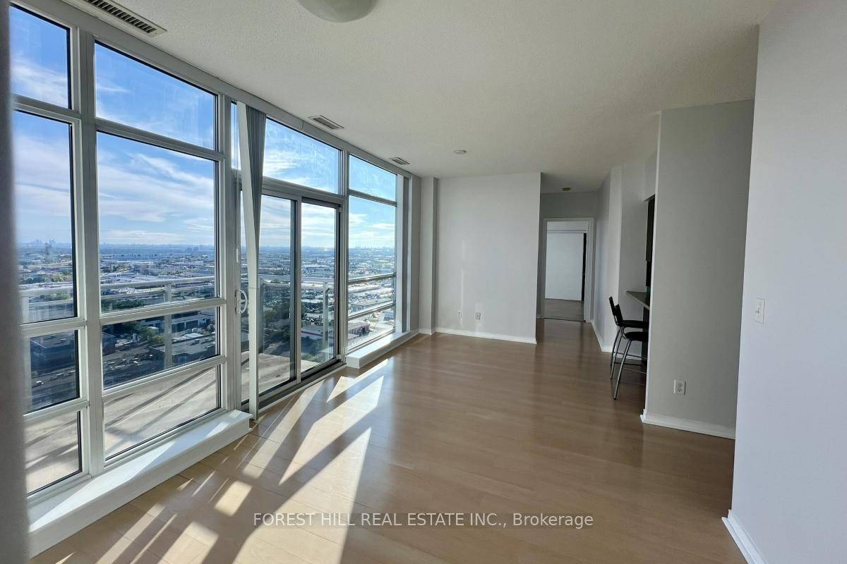 Penthouse unit featuring floor to ceiling windows, 9 foot ceilings, and laminate flooring throughout.