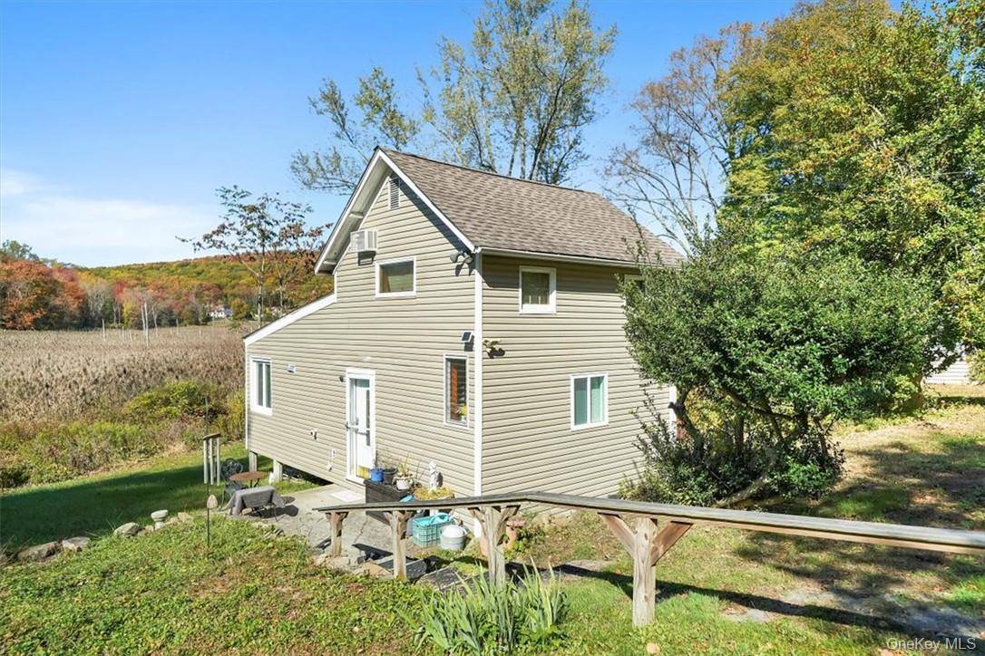 What a view ! This beautifully updated cottage style home is set on 1.