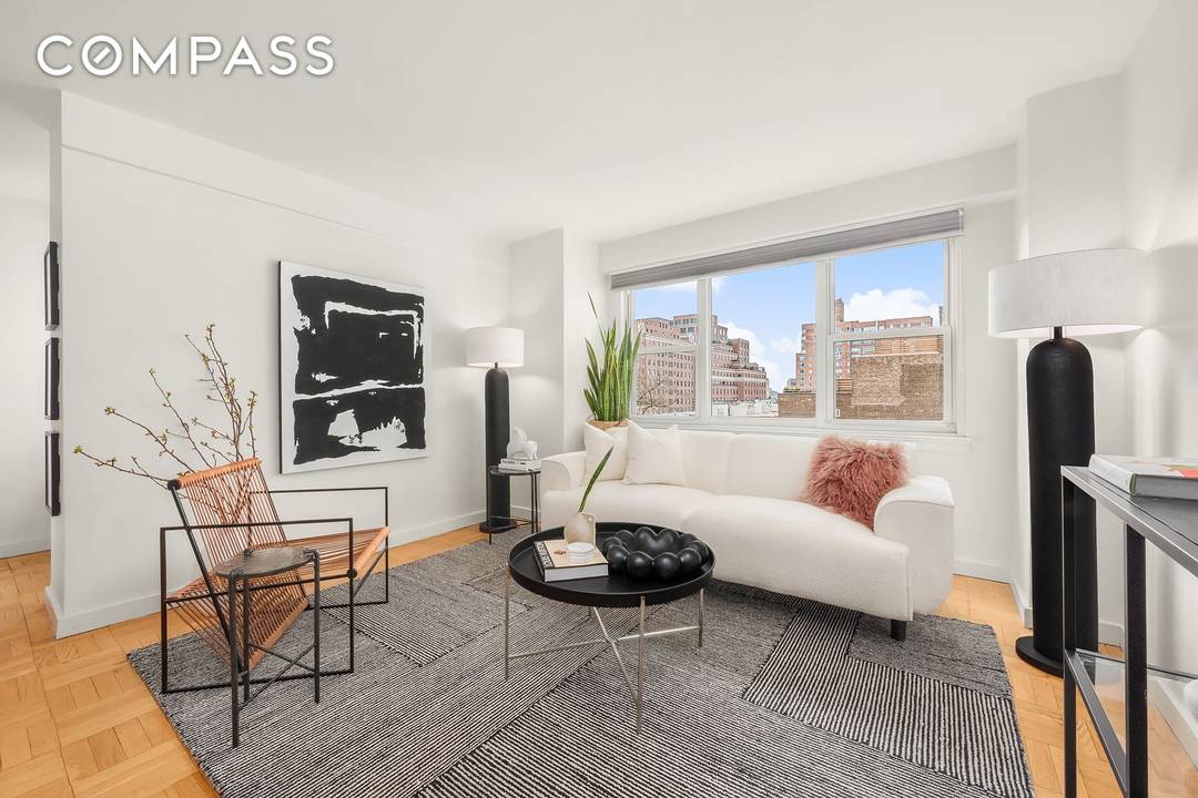 Welcome home to this sun drenched, loft like alcove studio in a white glove doorman building in the heart of The Village.