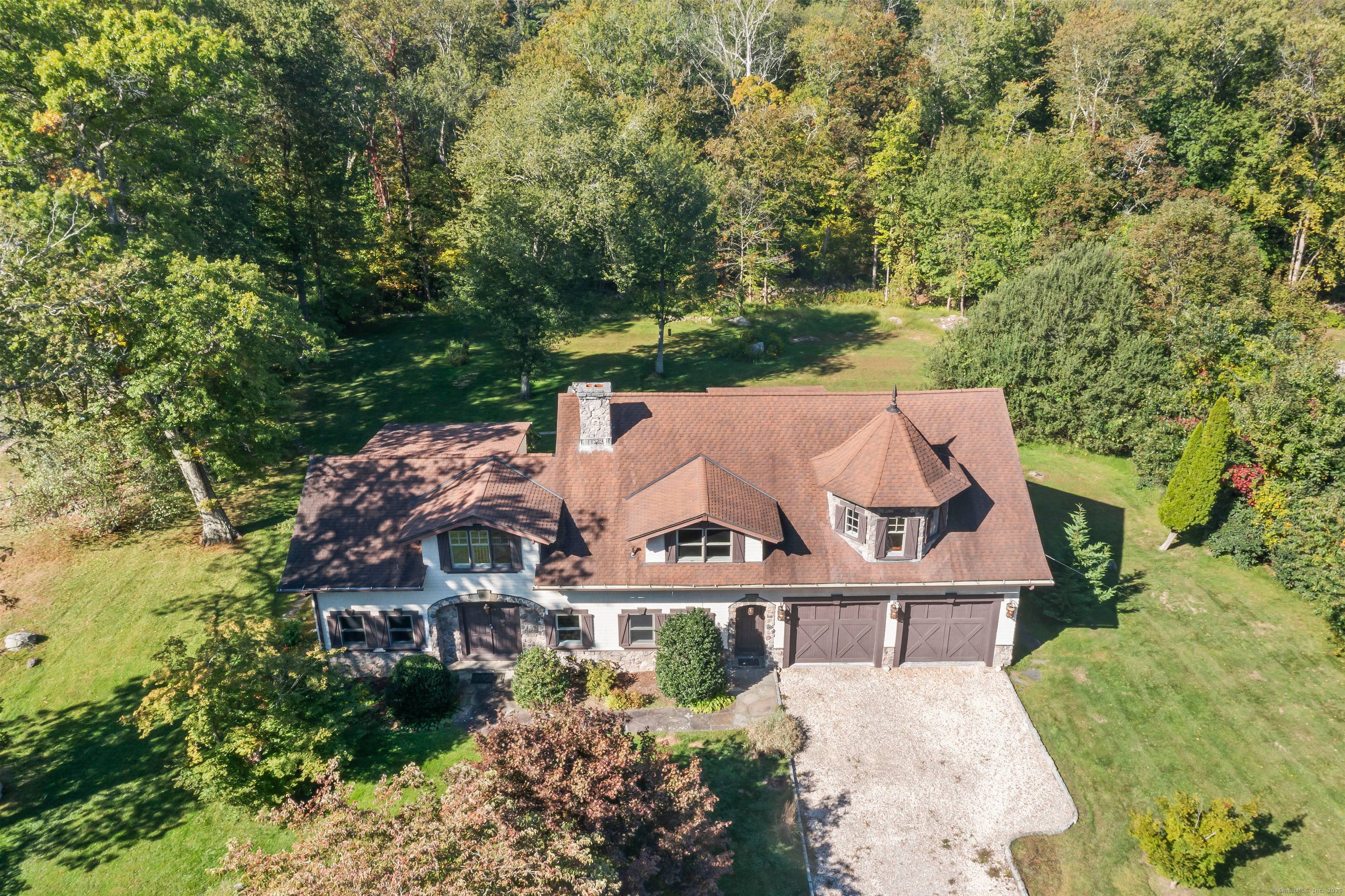 Reminiscent of an European Estate this 4420 square foot home features, four bedrooms, two full bathrooms and two half bathrooms on an open acre of land.
