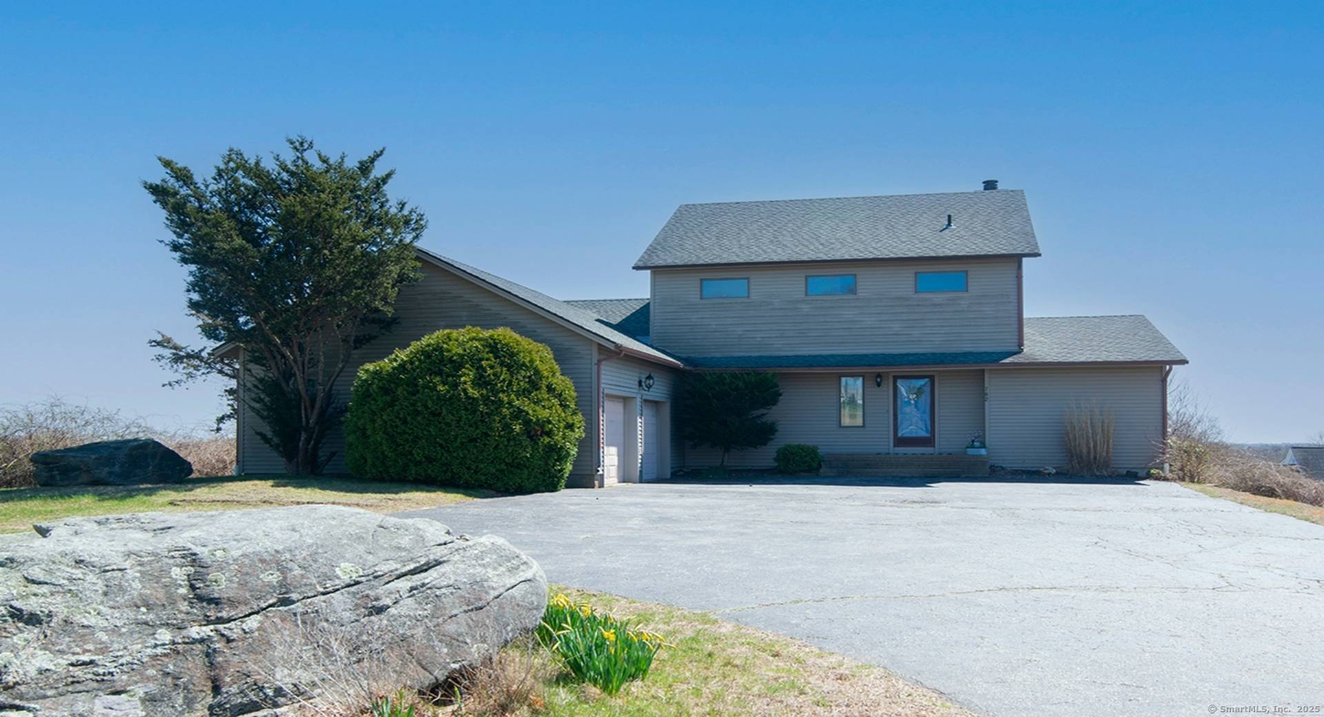 Enjoy stunning vistas of Fishers Island Sound from this hilltop property in Noank.