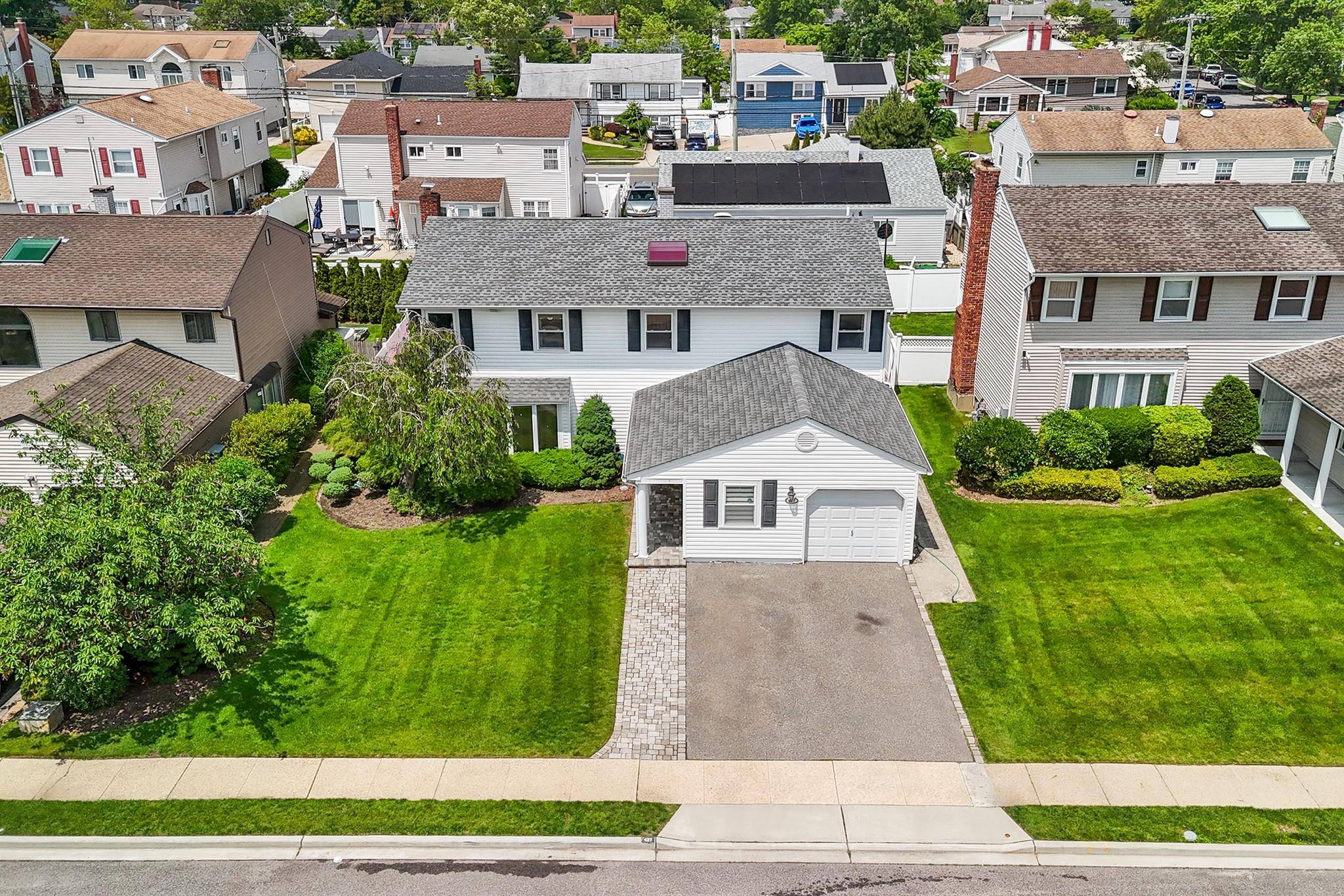 Welcome to 427 Benito St, a charming Colonial in East Meadow featuring a classic brick and vinyl exterior with great curb appeal.