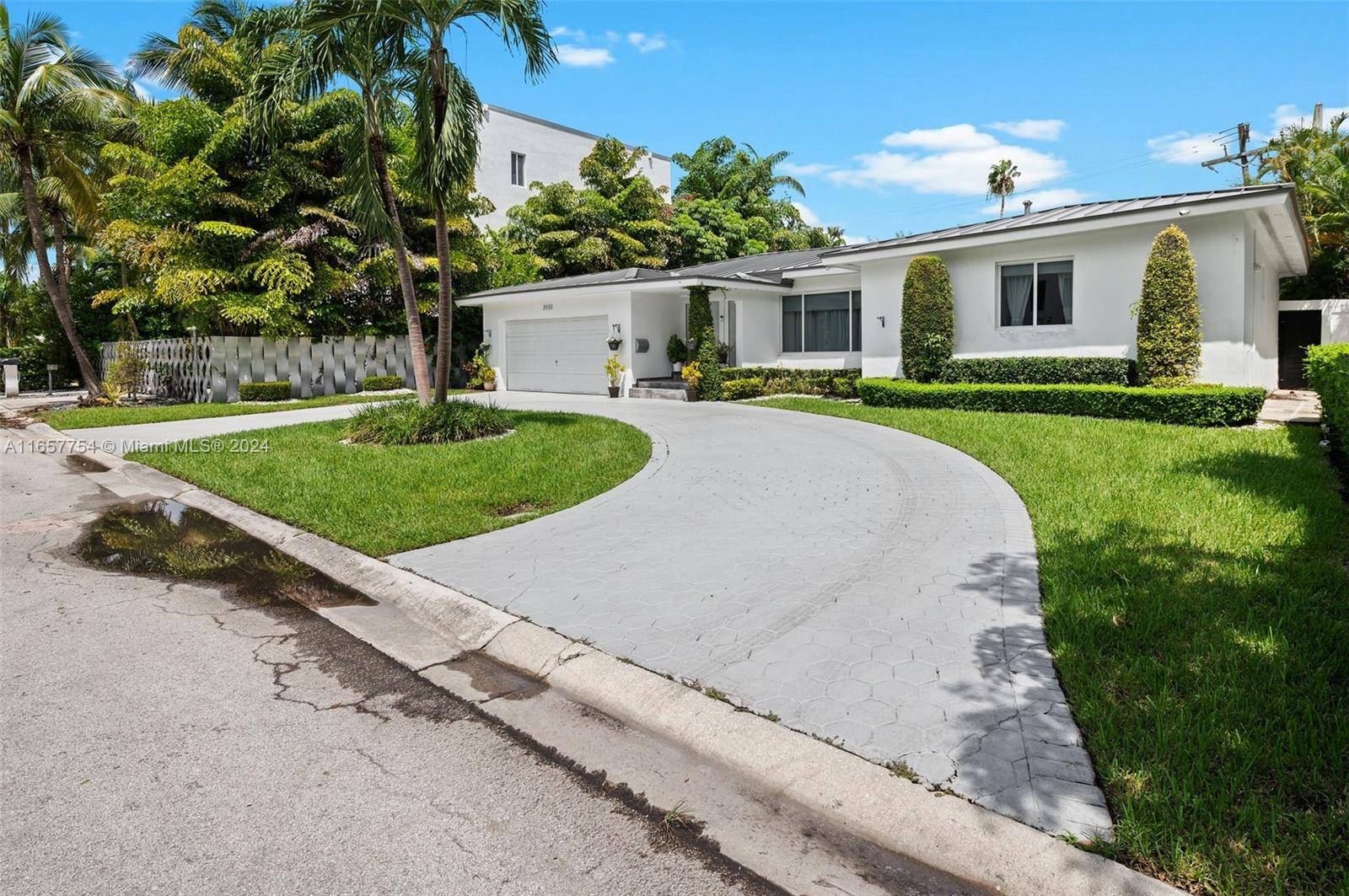 Elegantly reimagined, this 4 bedroom, 3 bathroom residence is tucked in a peaceful cul de sac in prestigious North Coconut Grove.