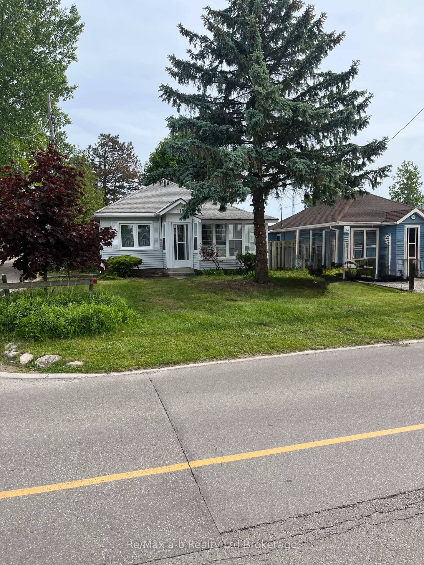 Fun in the Sun ! ! This charming three bedroom YEAR ROUND cottage is situated on a corner lot off the main street, only mere steps to the beach.