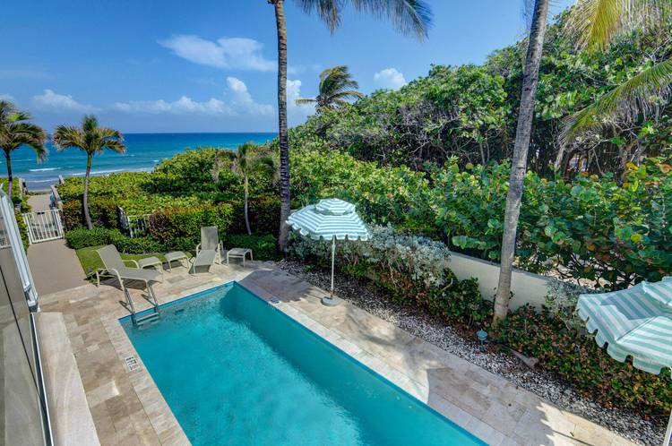 LIVE '' RIGHT ON THE SAND'' IN THIS 3 STORY TOWNHOME WITH OCEAN VIEWS !