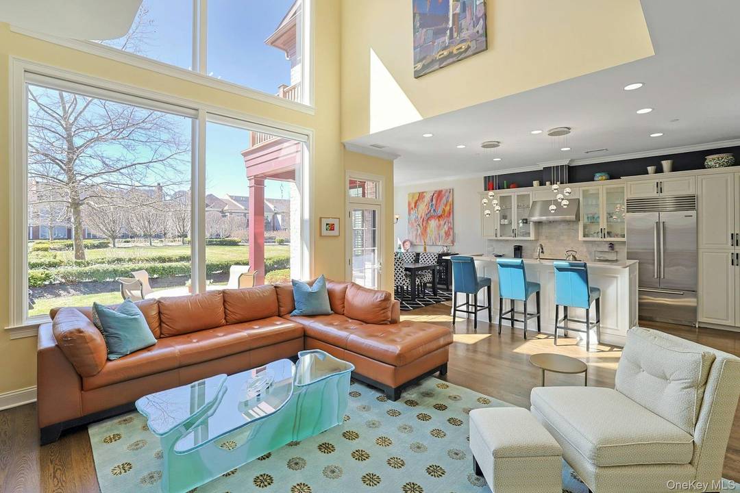 Open amp ; Bright Living with dramatic double height wall of windows.