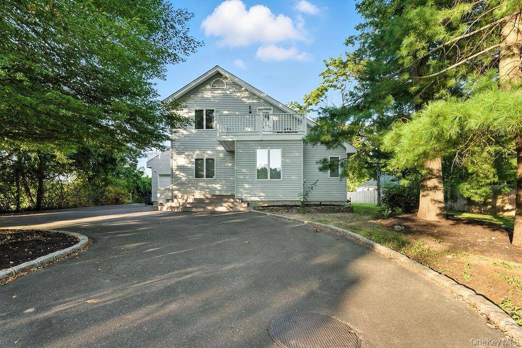 Welcome home to this secluded and bright home nestled next to a beautiful apple orchard in the heart of Jamesport Hamlet.