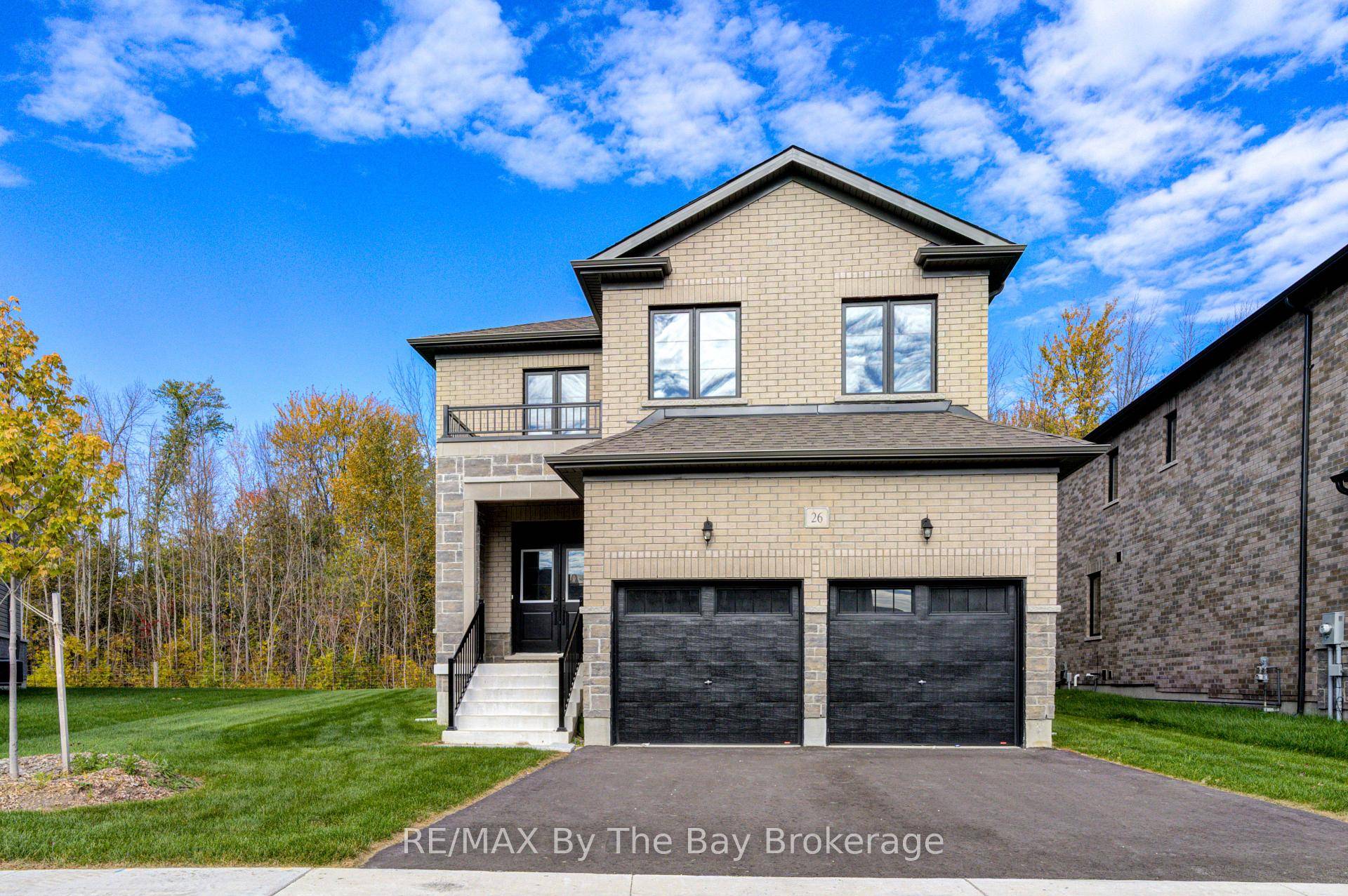 Welcome to 26 Amber Drive, a stunning Redwood Model featuring an all brick and stone exterior with an upgraded black window package.