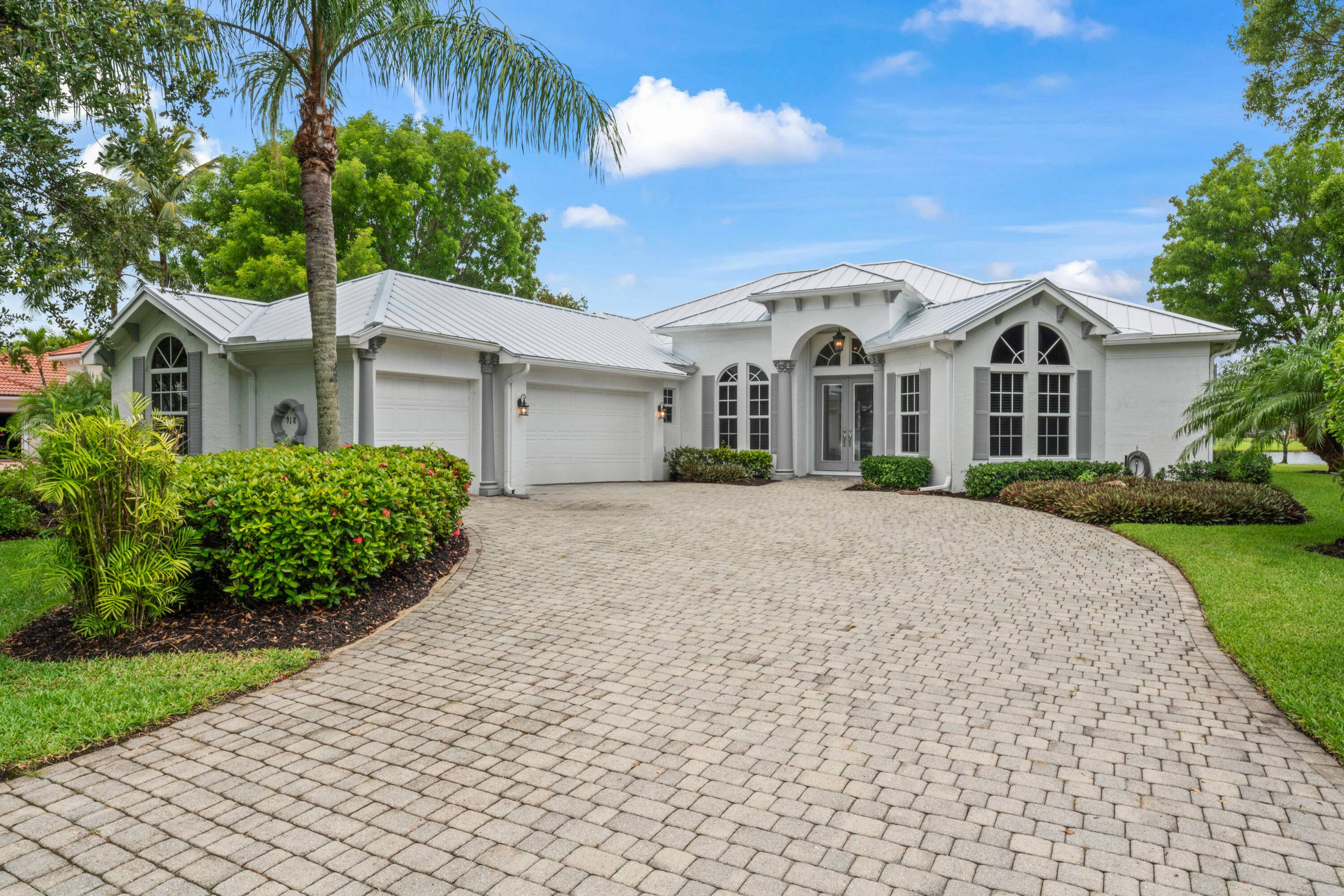 Stunning lakefront home in Florida Club with sweeping views, SW exposure, and privacy on an oversized lot.
