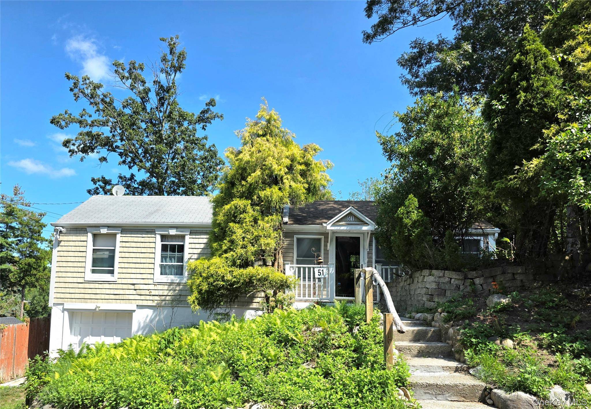 Beautiful Raised Ranch with winter water view, located near a private beach, featuring 2 bedrooms and 1 full bath.