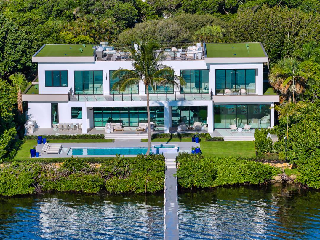 Welcome to 1422 SE Atlantic Drive, a rare opportunity to own one of the most prestigious newly completed residences on Hypoluxo Island, near Manalapan.